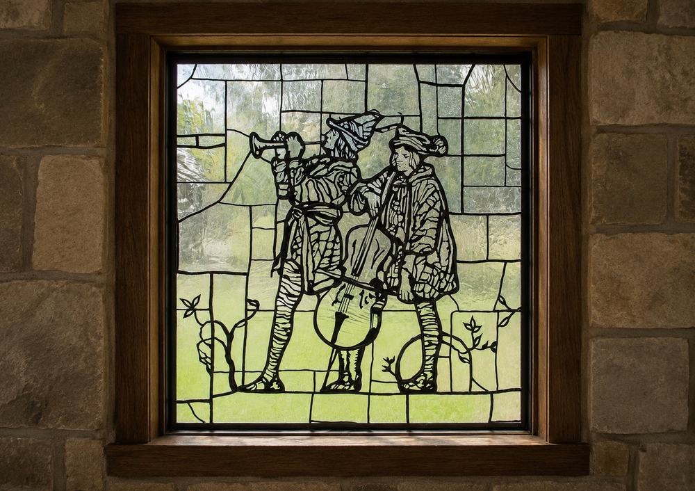 Carved lead glass window depicting medieval musicians, custom art glass