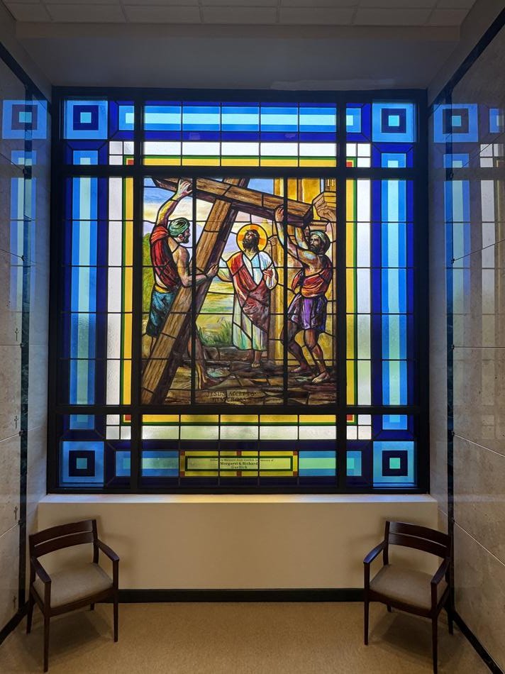 Painted ecclesiastical stained glass Stations of the Cross window depicting Jesus accepting his cross, with Prairie-style geometric border