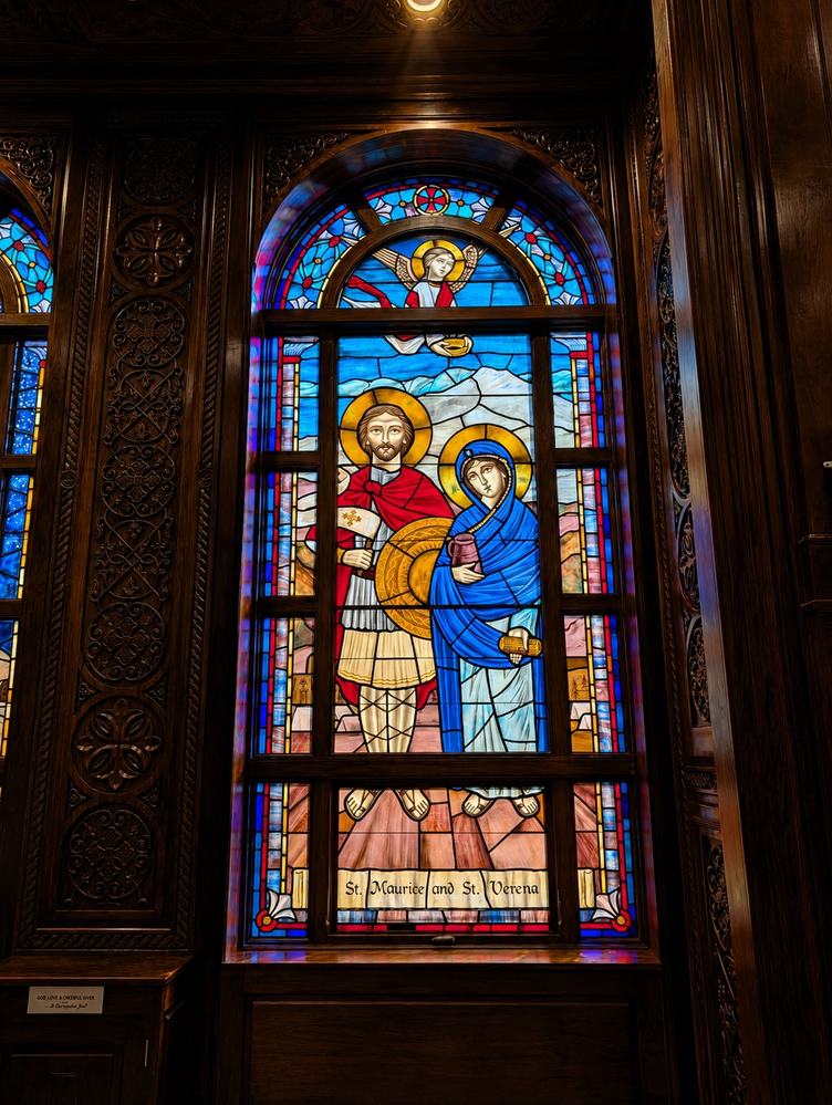 Painted ecclesiastical stained glass window of St. Maurice and St. Verena with angel
