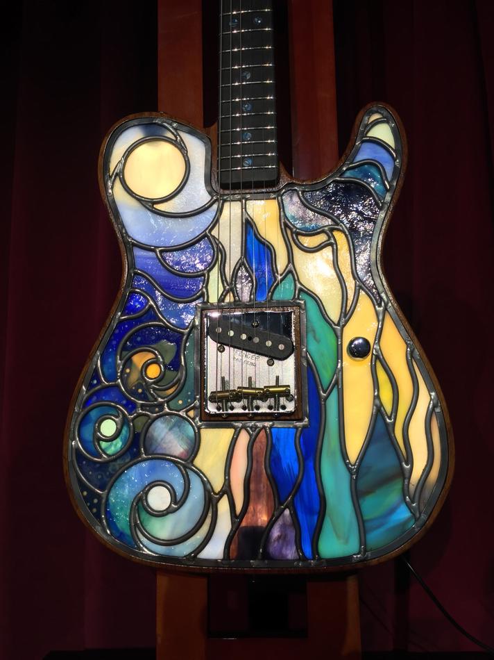 Custom stained glass electric guitar body with abstract wave and celestial design