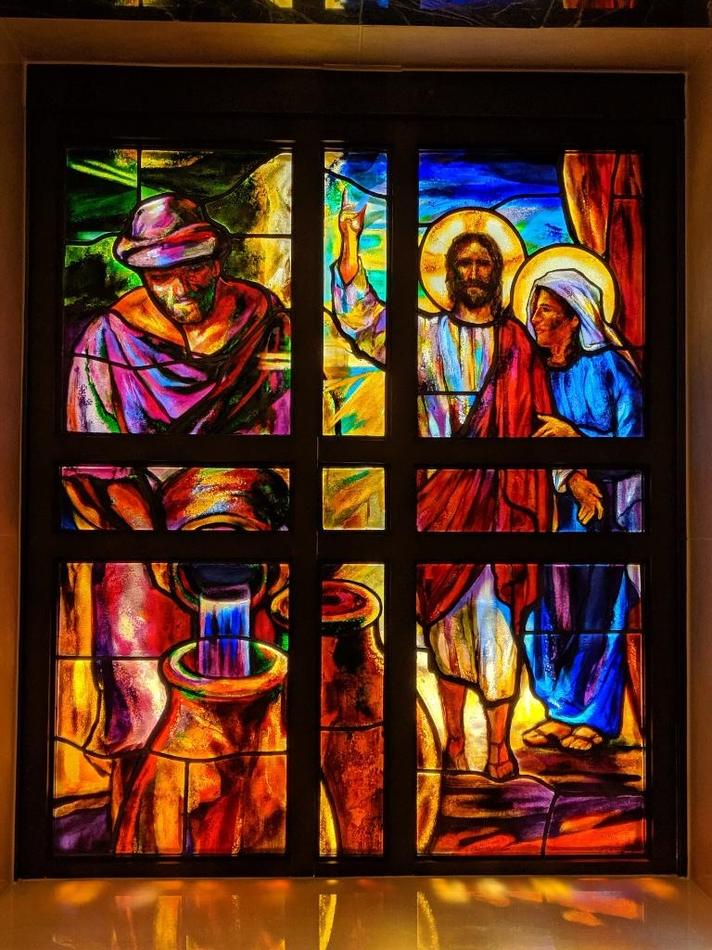 Painted ecclesiastical stained glass window depicting the Woman at the Well biblical scene